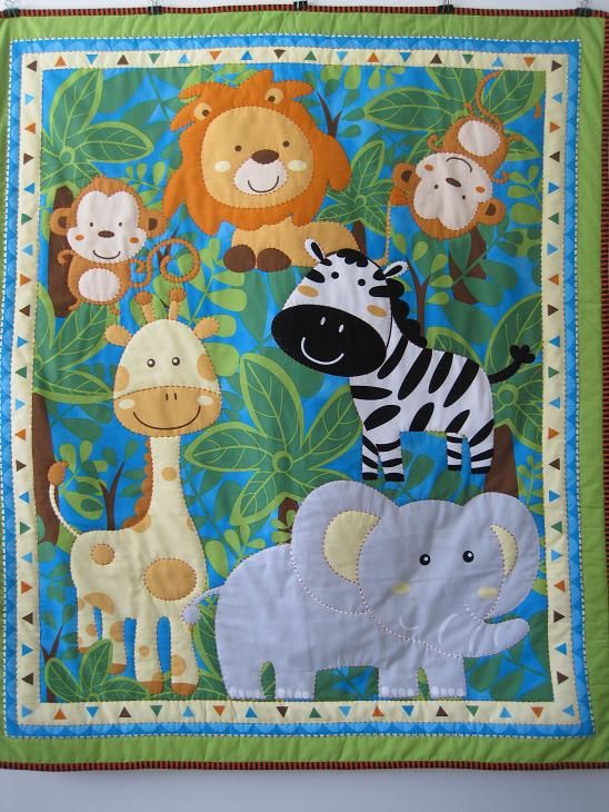 a wall hanging with animals and giraffes on it