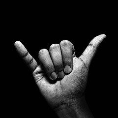 black and white photograph of a person's hand making the v sign with their fingers