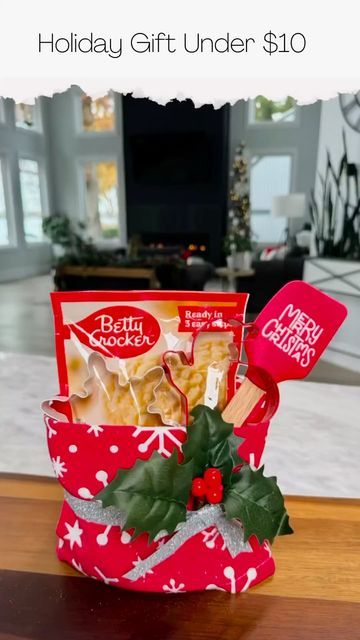 the holiday gift under $ 10 is in a red bag with holly and candy canes