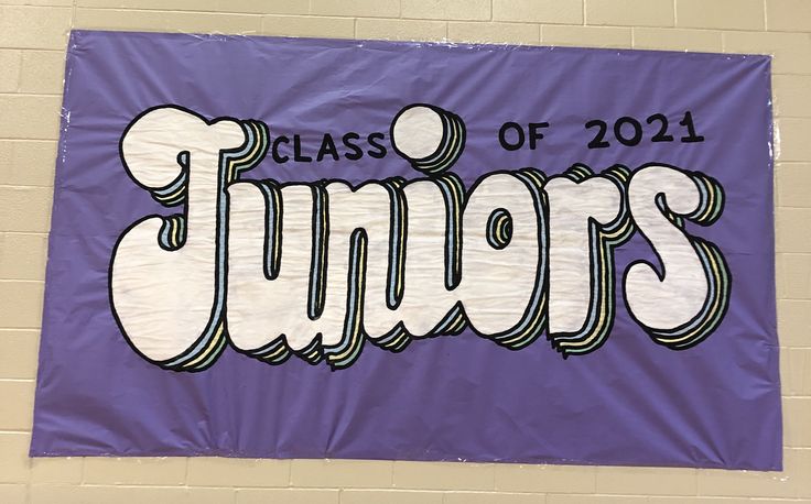 a purple banner with the words class of 2011 on it in front of a brick wall