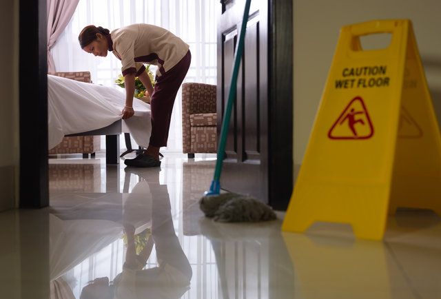 a man is cleaning the floor with a mop