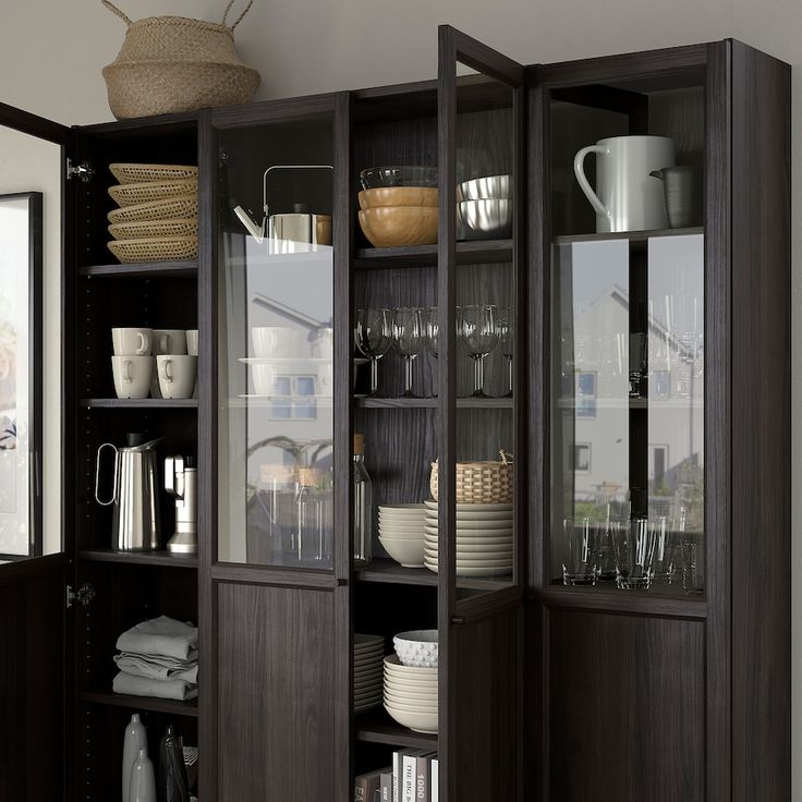 an open bookcase filled with dishes and cups