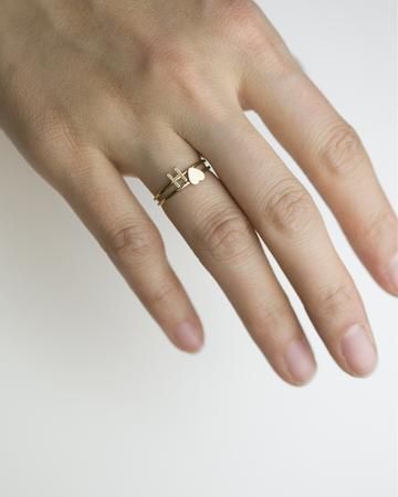 a person's hand with a ring on it