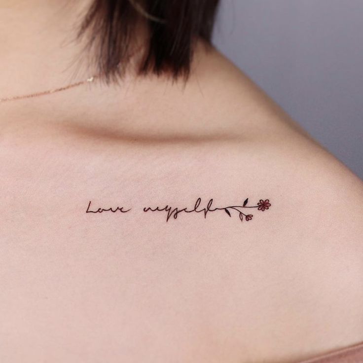 a woman with a tattoo on her shoulder that says love is imperfectly written in cursive writing