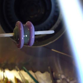 a close up view of an object that appears to be spinning on a stick with toothpicks in it