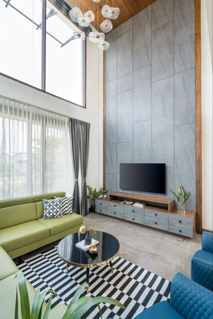 a living room filled with furniture and a flat screen tv on top of a wooden stand