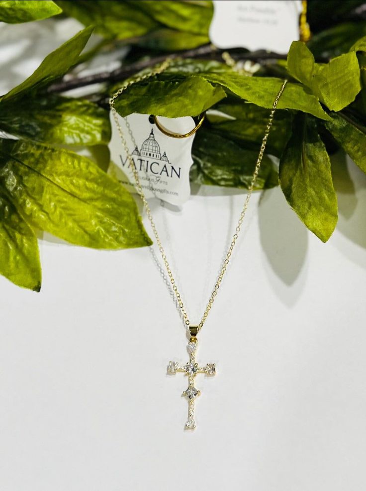 Holy Cross Religious Pendant Necklace Embrace divine elegance with our Cubic Zirconia Cross Pendant, meticulously crafted with precision. The cross, measuring 1.34 inches tall by 0.71 inches in width, radiates grace and sophistication. Its allure is enhanced by the exquisite 14K gold plating, adding a touch of opulence to your faith-inspired style. This elegant pendant comes complete with a 16-inch O-style chain, delicately designed and finished in 14K gold plating, featuring a two-inch extender Catholic Cross, Cross Jewelry Necklace, Divine Grace, Jesus Cross, Holy Cross, Gold Jewelry Necklace, Elegant Pendant, Meaningful Jewelry, Cross Jewelry