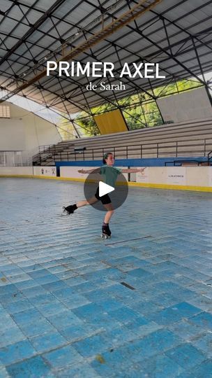 a man holding a dog on top of a blue tiled floor in an indoor arena