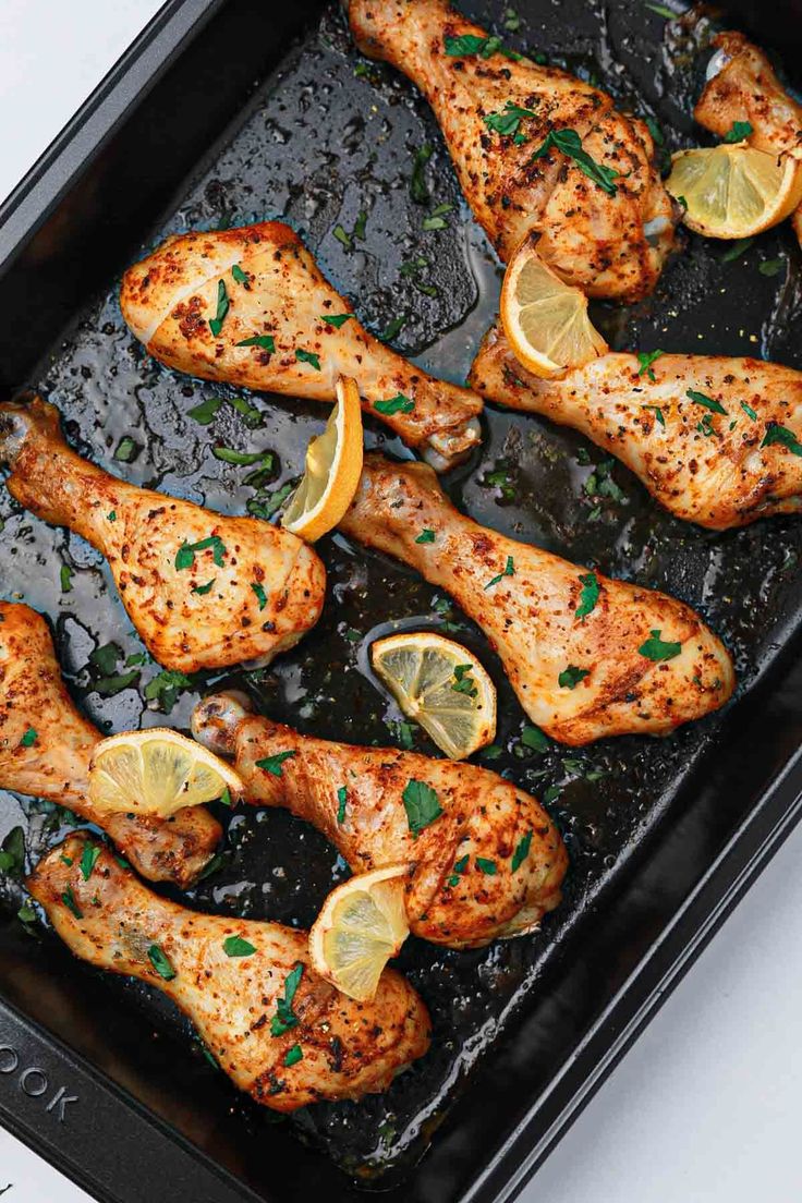 chicken with lemons and herbs in a pan