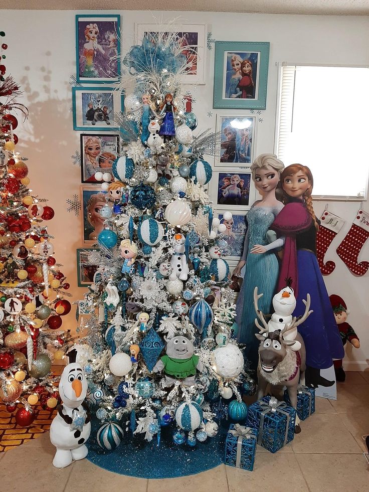 there is a christmas tree in the living room with frozen princesses and snowmen on it