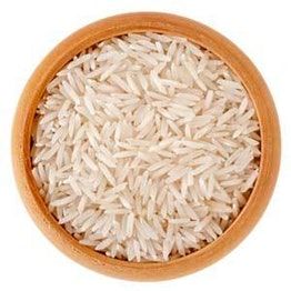 white rice in a wooden bowl on a white background