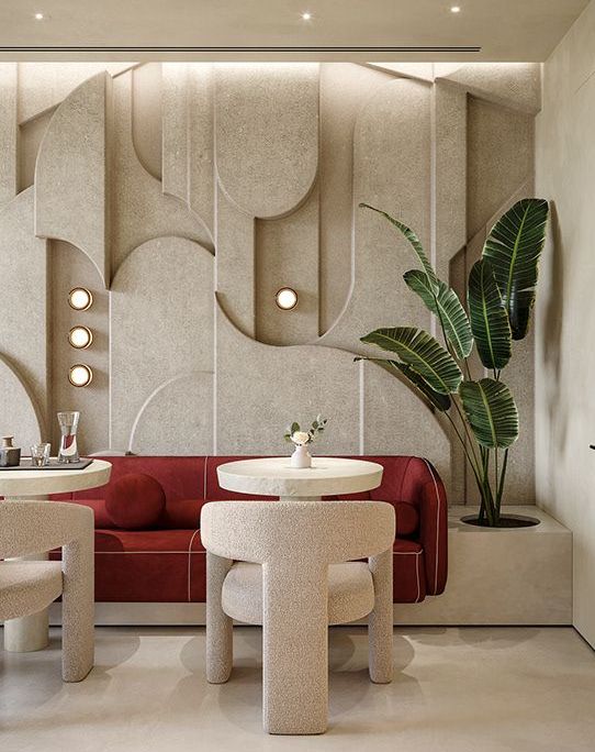 a living room filled with furniture next to a potted plant and two round tables