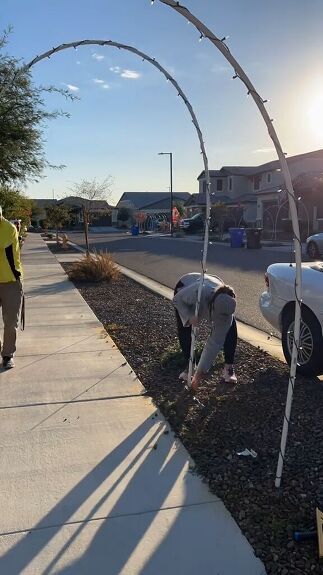 two men are working on an arch in the sidewalk