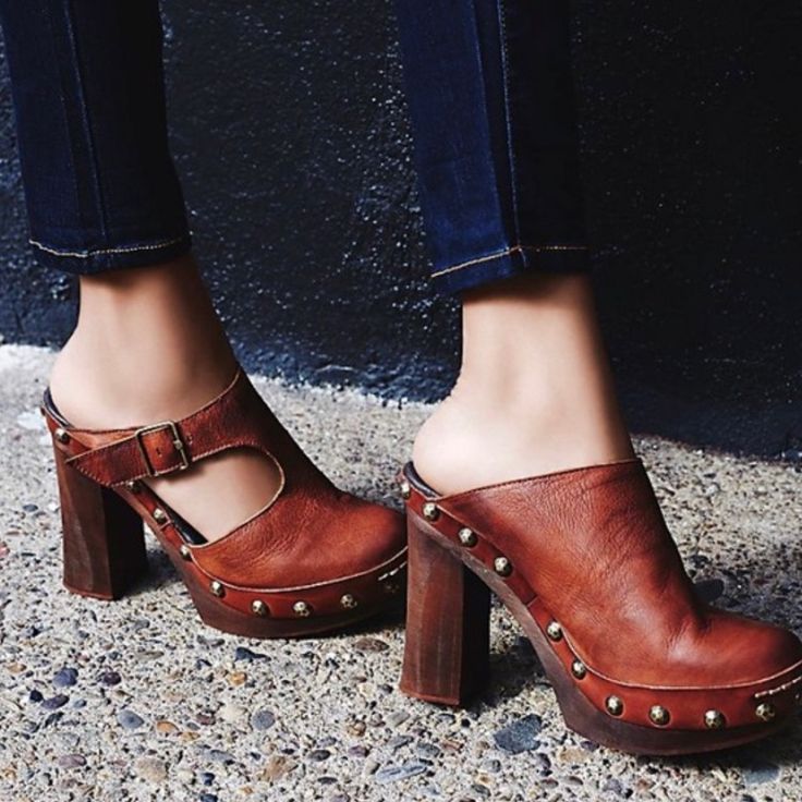 Brown Leather Clogs With Wooden Heels And Grommet Detail. Size Us 9 Eu 39 Chic Slip-on Clogs With Reinforced Heel, Fall Mules With Stacked Open Heel, Fall Mules With Stacked Heel And Open Heel, Fall Open Heel Mules With Stacked Heel, Chic Block Heel Clogs With Heel Strap, Chic Clogs With Heel Strap And Open Heel, Chic Almond Toe Platform Clogs, Brown Open Heel Mules For Fall, Chic Platform Clogs