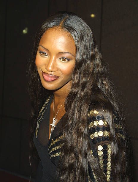 a woman with long hair wearing a black top