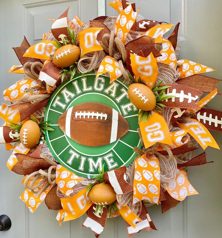 a football wreath with orange and green decorations