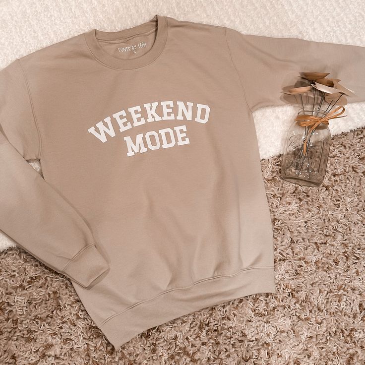 Tan sweatshirt with white Weekend Mode text .  All sweatshirts are personally designed and heat pressed on high quality Gildan sweatshirts. 50/50 cotton/poly, heavyweight, tear away label and machine washable. Unisex sizing, therefore these run large but give a perfect oversized vibe. Size down if you prefer a smaller fit. Check the size chart for reference.  Your item is handmade with love, therefore please treat it with love. It is recommended to wash inside out and dry on low heat/hang to dry for best long-term results.  Please allow 1-2 weeks for delivery. No returns or exchanges, but please contact me if you have any problems with your order. Trendy Crew Neck Sweats For Everyday, Trendy Crew Sweatshirt For Loungewear, Trendy Crew Neck Sweatshirt For Loungewear, Oversized Comfy Sweatshirt With Letter Print, Trendy Crew Sweats For Loungewear, Trendy Relaxed Fit Crew Sweats, Trendy Relaxed Fit Sweats For Everyday, Long Sleeve Graphic Print Sweatshirt For Weekend, Graphic Print Long Sleeve Sweatshirt For Weekend