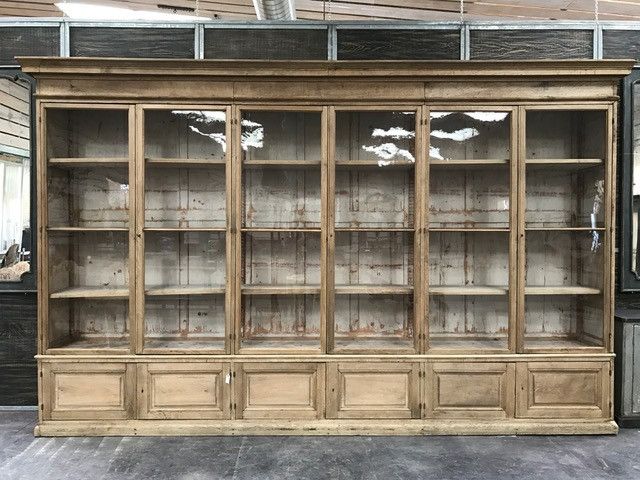 an old wooden bookcase with glass doors