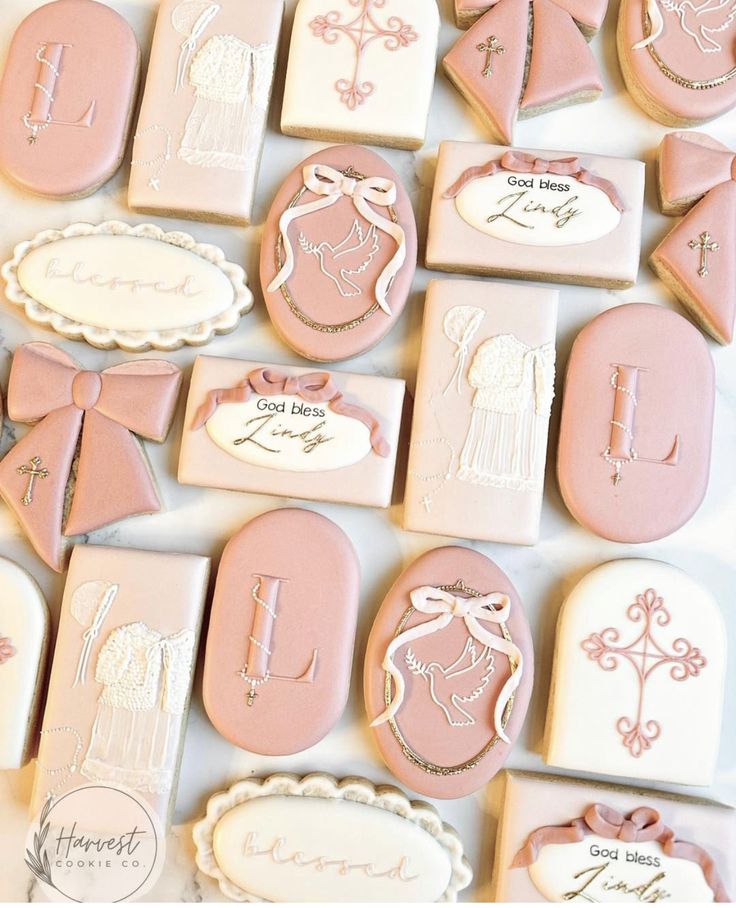 pink and white decorated cookies with names on them