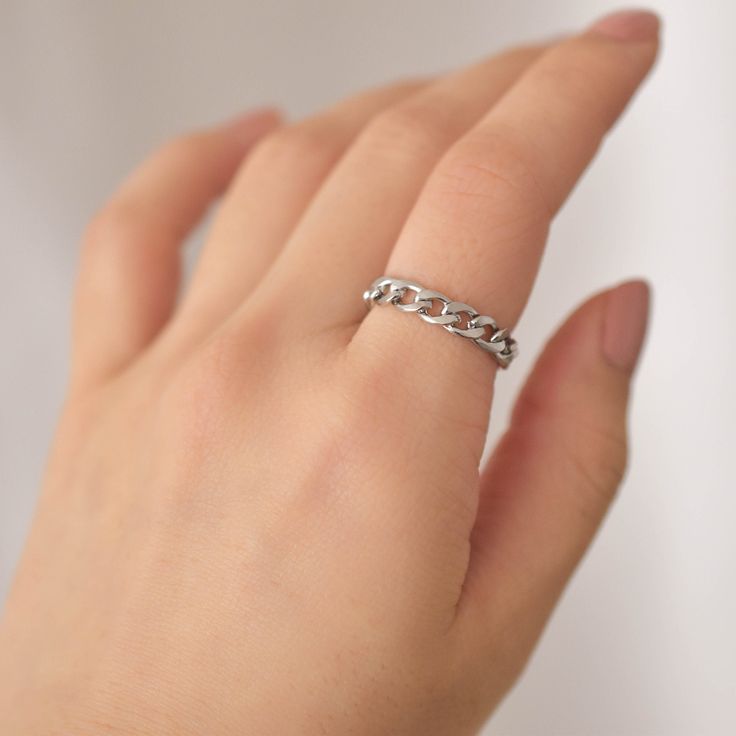 A simple silver ring featuring a chain design. This ring is collapsible so it will conform to your finger and is very comfortable to wear daily. Made of surgical steel, which features a deep, true silver color, this piece of jewelry is hypoallergenic, water-resistant, and tarnish-resistant. --------------------♥ PROMOS ♥-------------------- Want 10% off? Join the mailing list by visiting http://bit.ly/vedern . --------------------♥ BUY WITH CONFIDENCE ♥-------------------- Don't love it? Message Trendy Silver Round Chain Ring, Trendy Silver Rings With Adjustable Chain, Trendy Silver Chain Ring As Gift, Trendy Silver Chain Ring Gift, Silver Open Metal Chain Ring, Silver Adjustable Chain Ring, Silver Minimalist Chain Ring, Silver Minimalist Open Chain Ring, Minimalist Silver Midi Rings With Adjustable Chain