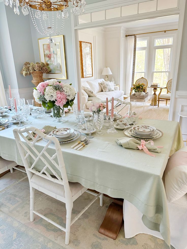 a dining room table is set with plates and silverware