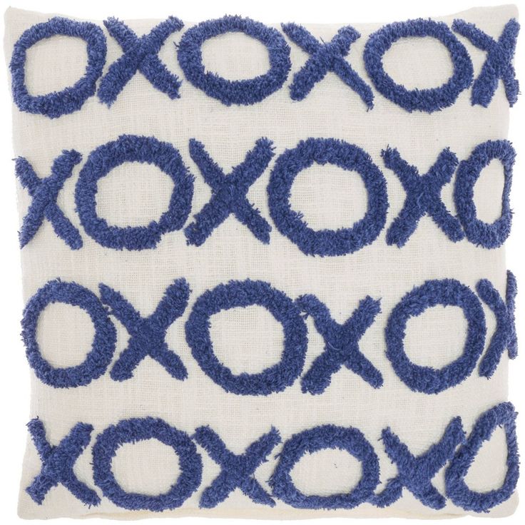 a blue and white decorative pillow with circles on it's side, in the shape of an xoxo pattern