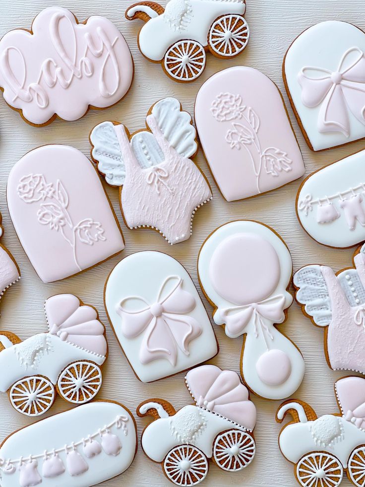 baby shower cookies decorated with royal icing and fondant decorations, all in pastel pink