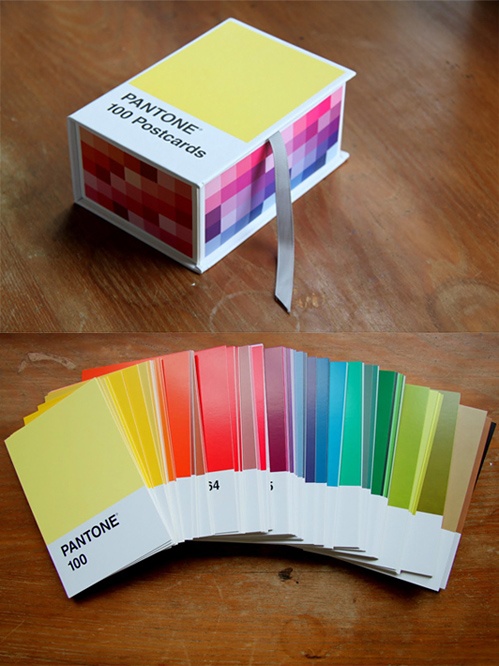 several different colors of paper sitting on top of a wooden table