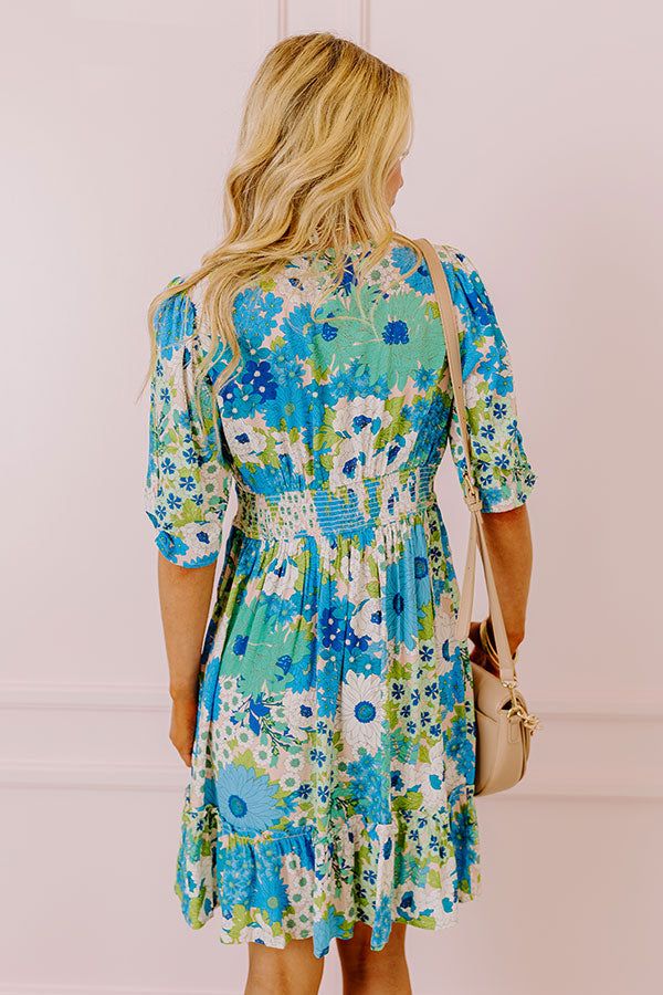 You will be the buzz of the town when you arrive in this pretty blue dress featuring lightweight breezy material patterned with a teal, green, and white floral print, a v-cut neckline with a front tie detail, loose half sleeves, and a relaxed skirt silhouette that falls into a straight mid-thigh length hemline! on products Measurements S : Bust 34", Hip 38", Length 36", Sleeve Length 12.5", Waist 28-30". M : Bust 36", Hip 40", Length 36", Sleeve Length 13", Waist 30-32". L : Bust 38", Hip 42", L Blue Printed Mini Dress For Spring, Blue Ditsy Floral Print Knee-length Dress, Blue Floral V-neck Dress For Vacation, Blue Summer Mini Dress For Garden Party, Summer Mini Dress For Garden Party In Blue, Blue Floral Sundress For Garden Party, Blue Floral Print Mini Dress For Day Out, Light Blue Summer Floral Dress For Vacation, Blue Knee-length Ditsy Floral Dress