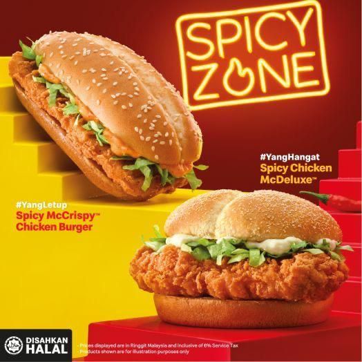 a chicken sandwich with lettuce and mayonnaise next to a spicy zone sign