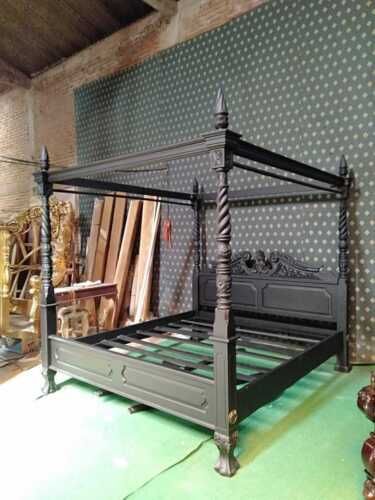 an antique bed frame in the middle of a room with polka dots on the walls