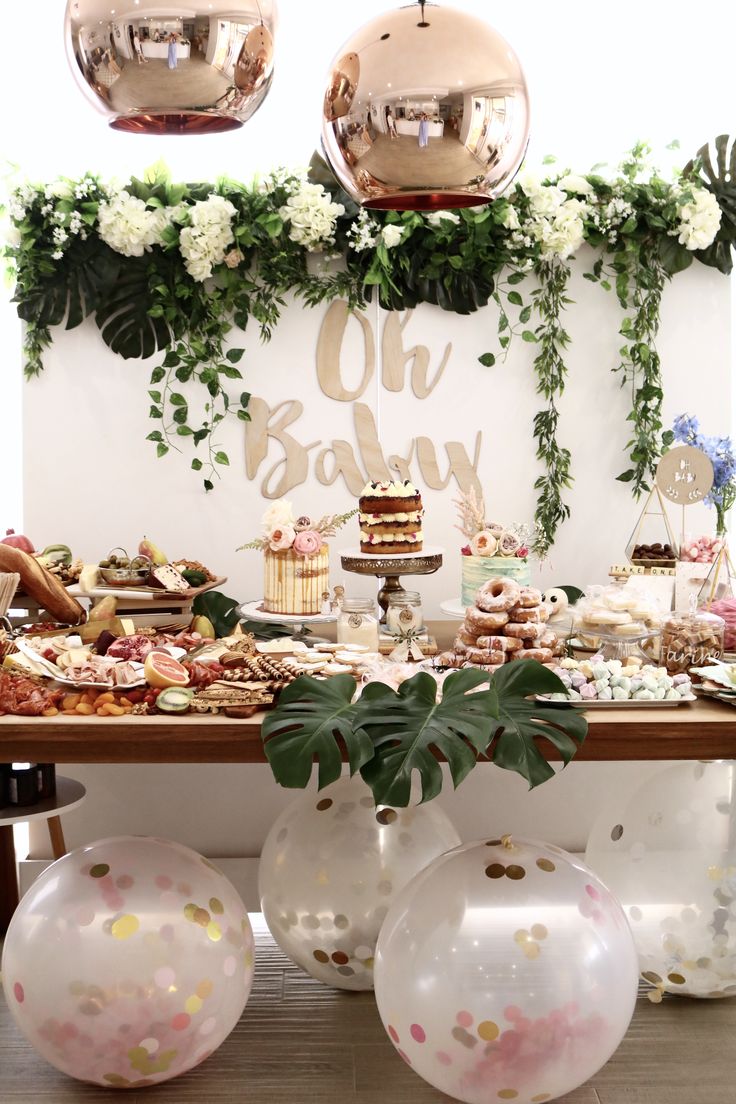 a table topped with lots of cake and desserts covered in confetti on top of plates