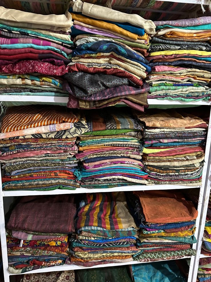 a closet filled with lots of different colored fabrics