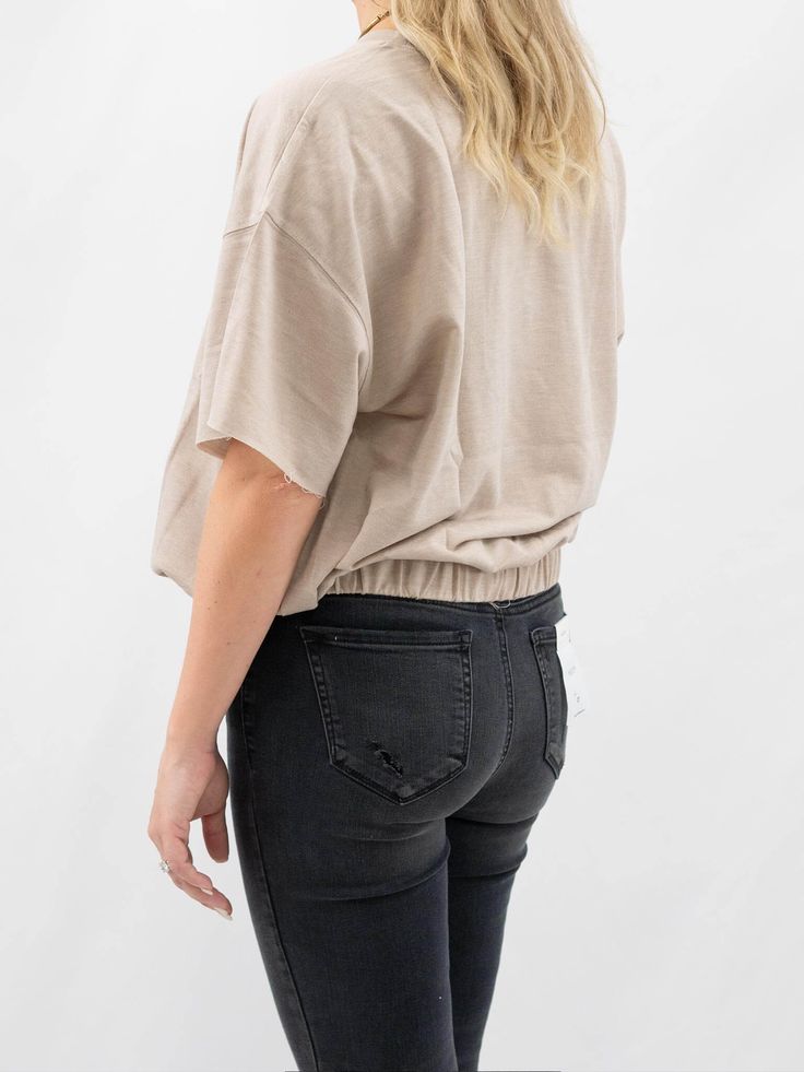 Oversized, but slightly fit in this Cinched Waist Tee. It features a loose short sleeve fit, round neck, and a cinched elastic waist. SIZE & FIT Fit is true to size Model is 5'6" wearing size small Short Sleeve Tops With Elastic Waistband For Loungewear, Everyday Cotton Tops With Ribbed Waistband, Cotton Tops With Ribbed Waistband, Trendy Drawstring Tops For Loungewear, Trendy Slouchy Tops For Everyday, Trendy Tops With Relaxed Fit And Batwing Sleeves, Casual Boxy Top With Shirttail Hem, Casual Short Sleeve Top With Relaxed Fit, Casual Crew Neck Short Sleeve Top For Loungewear