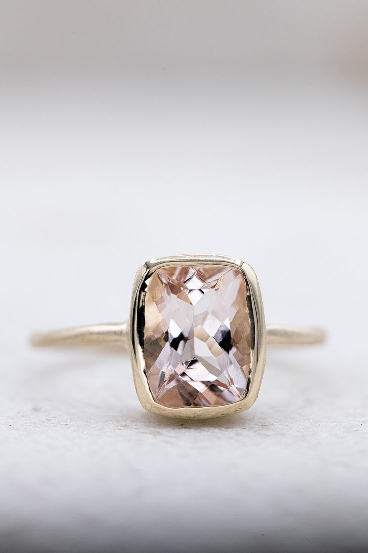 14k Yellow Gold and Pink Beryl Solitaire, Cushion Cut Statement Ring, Diamond Alternative Engagement Morganite gems exhibit the pleochroism effect that exhibits different colors when viewed from different angles. Here are the details on this one: The color is a light pink/lavender and measures 7mm x 9mm and weighs approximately 2.5 carats. The handmade setting is 14k yellow gold with subtle facets along the slender band. Morganite is a 7.5 on the MOHS scale and exhibits a glowing affect in low l Unique Morganite Engagement Ring, Morganite Engagement Ring Yellow Gold, Light Pink Diamond Engagement Ring, Modern 14k Gold Topaz Wedding Ring, Modern 14k Gold Topaz Ring With Center Stone, Modern 14k Gold Topaz Ring, Modern 14k Gold Rings With Accent Stones, Modern 14k Gold Topaz Ring With Bezel Setting, Modern 14k Gold Cushion Cut Ring