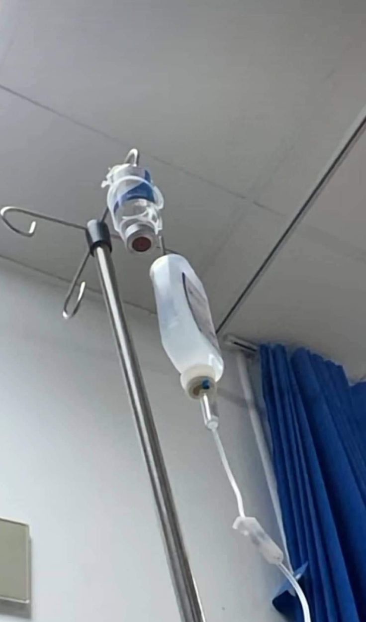 a hospital room with two medical equipment hanging from the ceiling