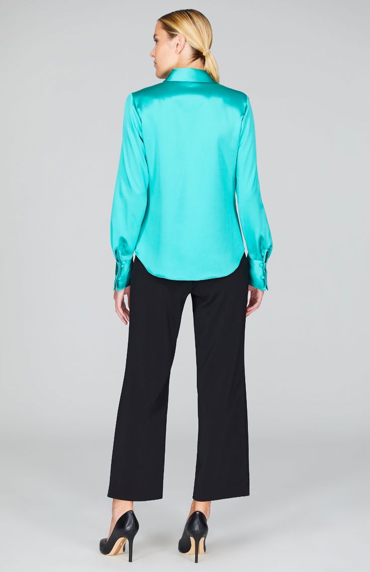 Our signature collared button down shirt is an elegant update to a wardrobe staple. Cut with a beautifully drapey and relaxed sleeve and finished with a wide angled cuff that can be worn long or folded up for maximum versatility. An easy way to add a pop of color and shine under a jacket, but strong enough to stand alone. Classic Long Sleeve Shirt With Blouson Sleeves, Elegant Collared Tops With Blouson Sleeves, Chic Office Shirt With Blouson Sleeves, Formal Fall Blouse With Shirttail Hem, Classic Collared Shirt With Blouson Sleeves, Chic Long Sleeve Shirt With Button Cuffs, Formal Solid Tops With Button Cuffs, Classic Blouson Sleeve Shirt For Work, Chic Shirt With Blouson Sleeves For Work