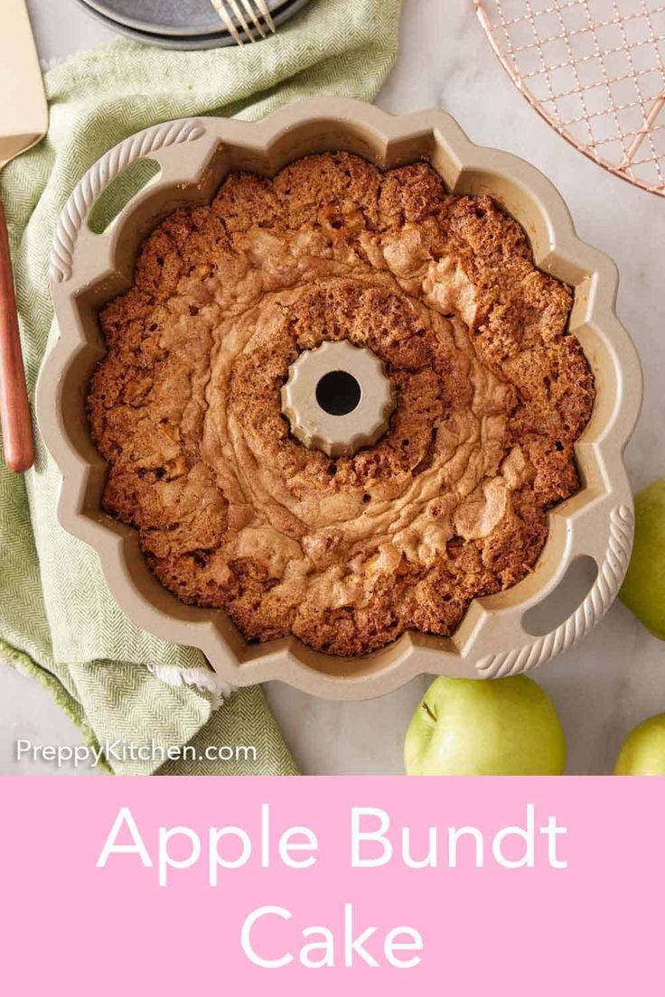 an apple bundt cake in a pan with apples around it