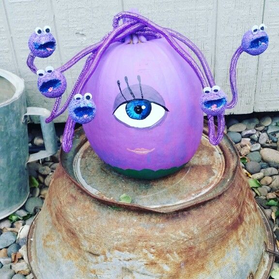 an odd looking purple ball with eyes on it