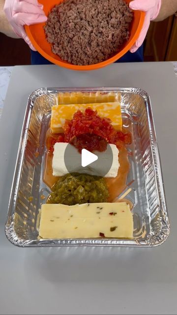 a person in pink gloves holding a bowl with food on it and an orange plate