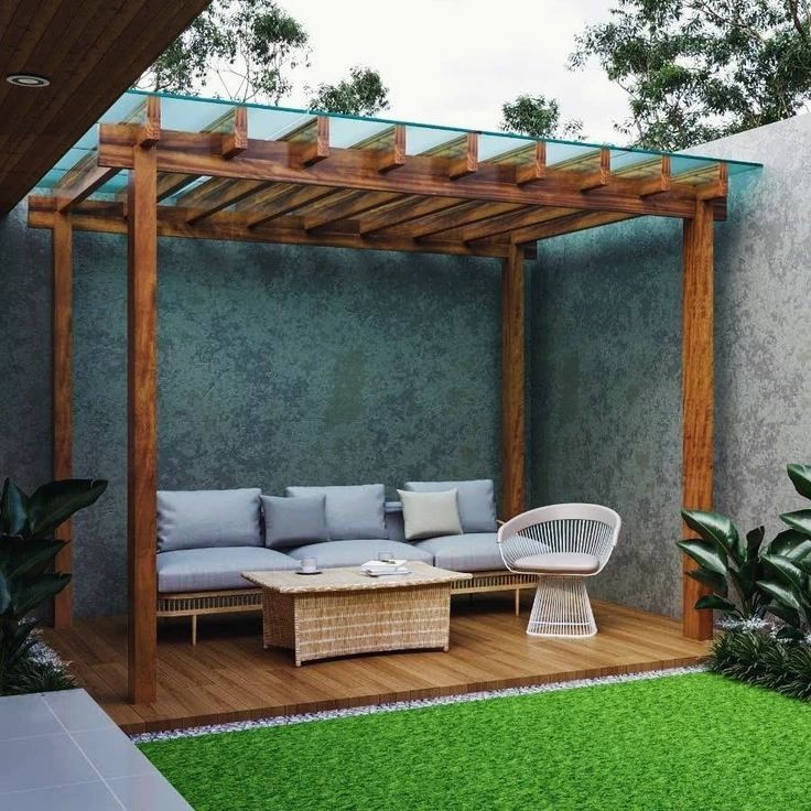 an outdoor living area with couches, tables and plants on the grass covered deck