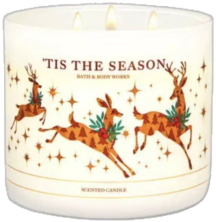 a white candle with two deers on it and the words tis the season written in red