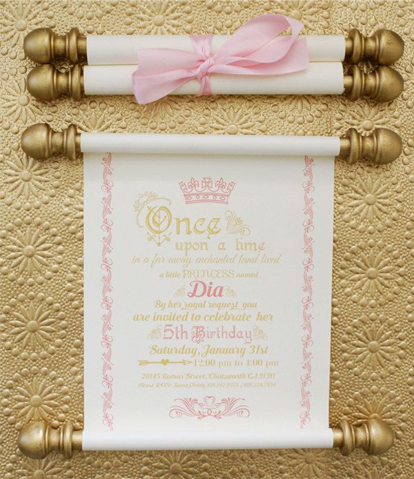 a pink and gold birthday party theme with a scroll on the wall next to it