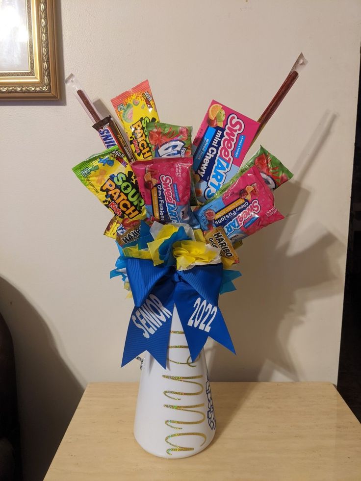 a vase filled with candy and candies on top of a table