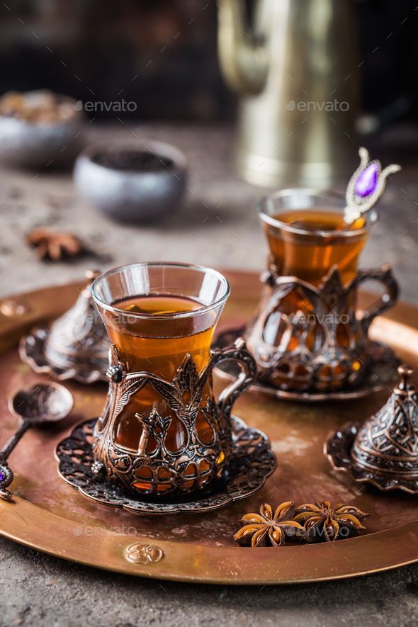 two cups of tea on a tray with spoons and other items - stock photo - images