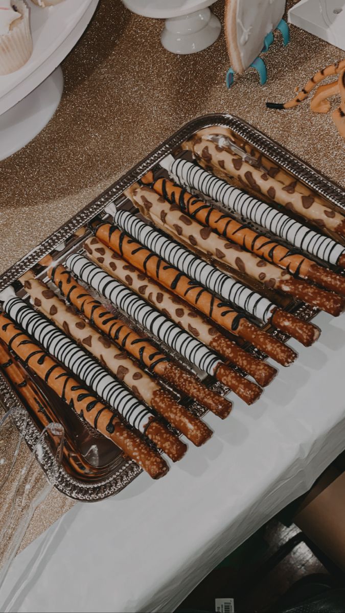 there are many tiger print desserts on the table ready to be cut and served