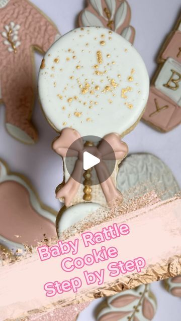 baby rattle cookie step by step with pink and gold decorations on it's side