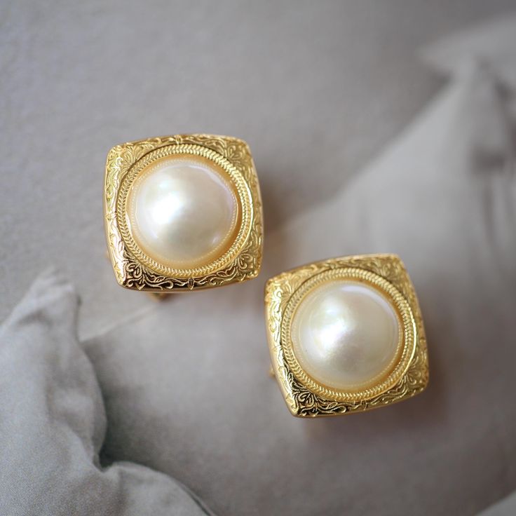 These stunning gold plated silver earrings feature a beautiful pair of hemisphere mabe pearl stones. With their intricate details and rich color, these push back studs are the perfect statement piece for any outfit. Handcrafted with care, these earrings are a true work of art and are sure to draw attention wherever you go. Whether you're looking for a unique gift or simply want to treat yourself. With their durable construction and timeless design, they're sure to become a beloved addition to yo Classic Clip-on Hoop Earrings As Gift, Luxury Gold Sterling Silver Clip-on Earrings, Gold Clip-on Hoop Earrings In Sterling Silver, Gold Sterling Silver Clip-on Hoop Earrings, Classic Plated Hoop Earrings For Anniversary, Elegant Gold Clip-on Earrings As Gift, Gold Earrings With Elegant Design For Gift, Classic White Gold Plated Earrings, Elegant Formal Clip-on Earrings