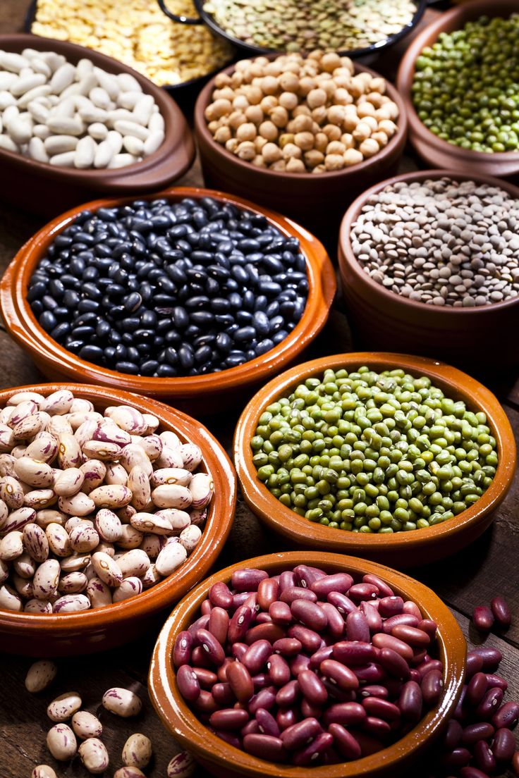 several bowls filled with different types of beans