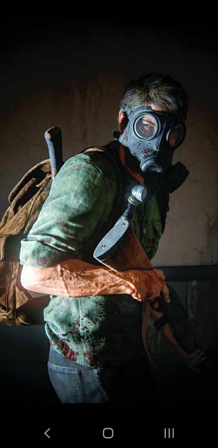 a man wearing a gas mask holding a knife